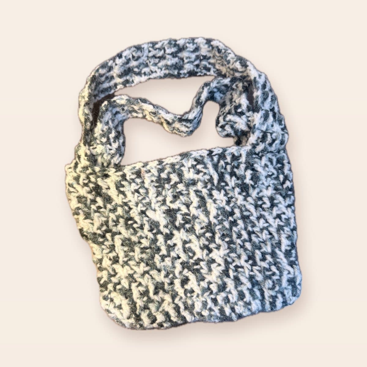 Charcoal and ivory marled crochet tote bag on a cream background